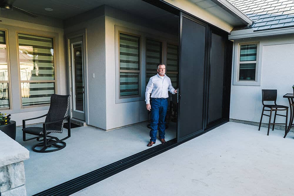 Patio enclosure with sliding screens